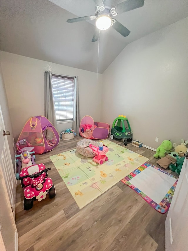 game room with ceiling fan, lofted ceiling, and hardwood / wood-style flooring