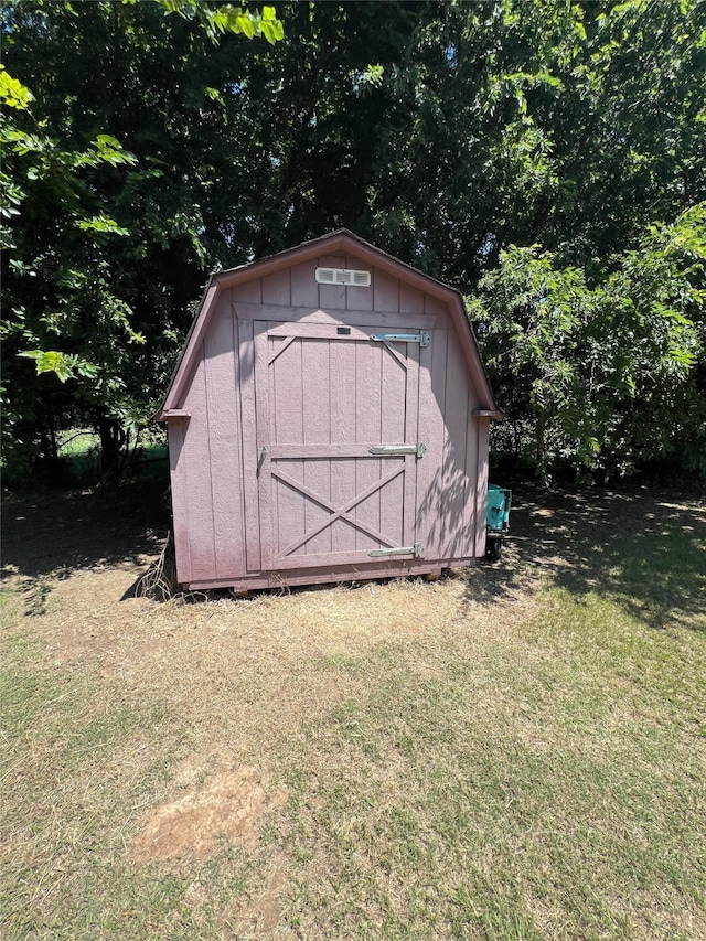 view of outdoor structure featuring a lawn