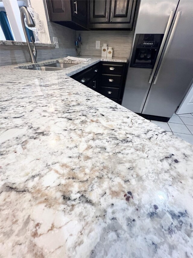 kitchen with sink and stainless steel refrigerator with ice dispenser