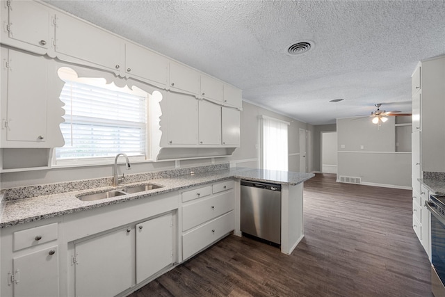 kitchen featuring kitchen peninsula, stainless steel appliances, white cabinetry, and sink