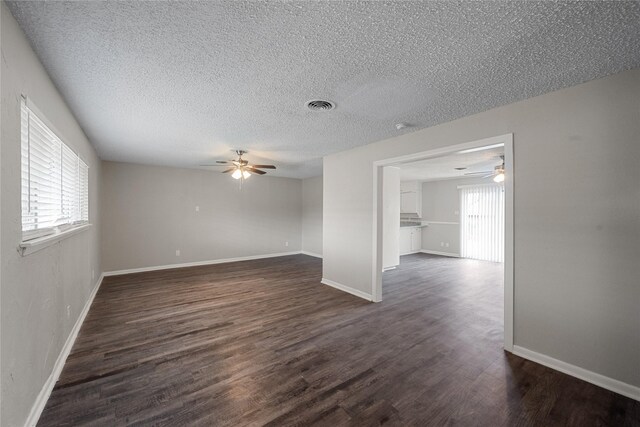 unfurnished room featuring a textured ceiling, dark hardwood / wood-style floors, and ceiling fan