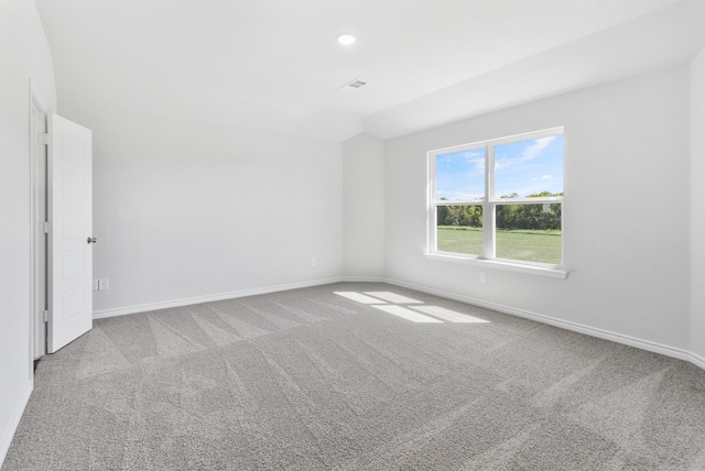 spare room featuring light carpet, recessed lighting, visible vents, and baseboards