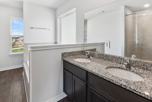 bathroom with vanity, plus walk in shower, and hardwood / wood-style flooring