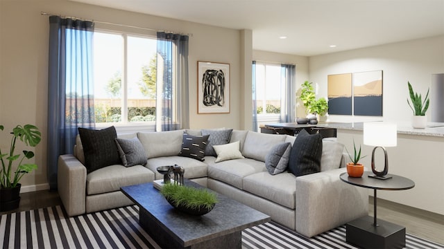 living area with recessed lighting, plenty of natural light, baseboards, and wood finished floors