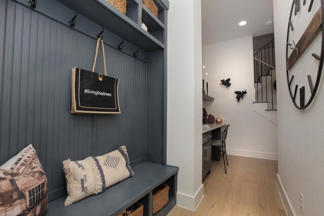 mudroom with baseboards, recessed lighting, and light wood-style floors