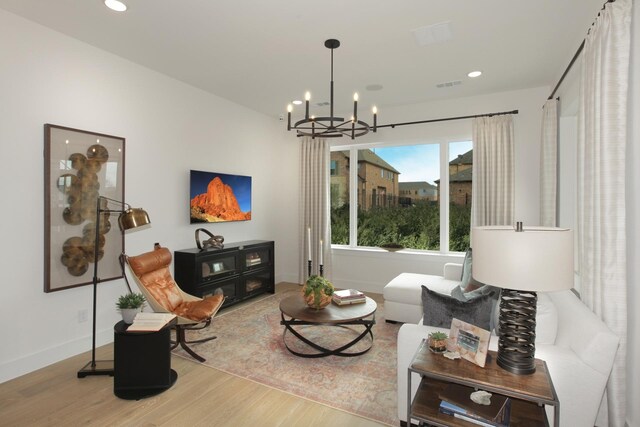 living room with recessed lighting, visible vents, wood finished floors, a chandelier, and baseboards