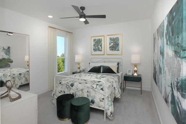 carpeted bedroom featuring a ceiling fan and baseboards