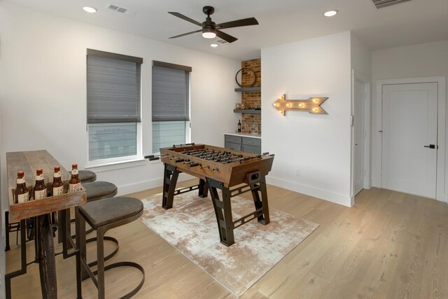 recreation room featuring baseboards, recessed lighting, visible vents, and light wood-style floors