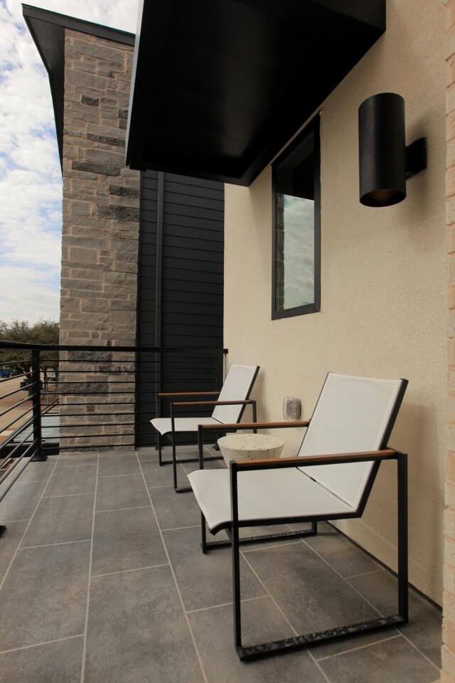 view of patio featuring a balcony