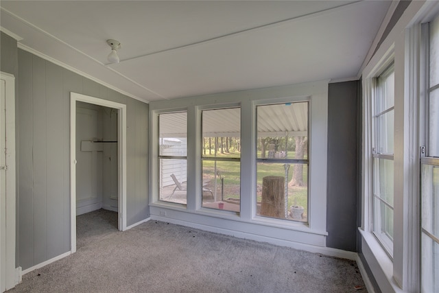 unfurnished sunroom with lofted ceiling and plenty of natural light