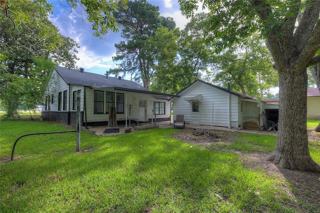 back of property featuring a patio and a lawn