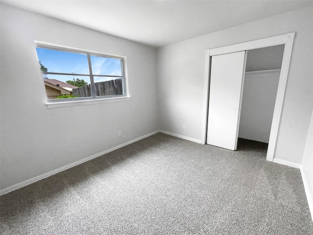 unfurnished bedroom featuring a closet and carpet flooring