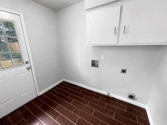 washroom featuring cabinets, gas dryer hookup, electric dryer hookup, and washer hookup