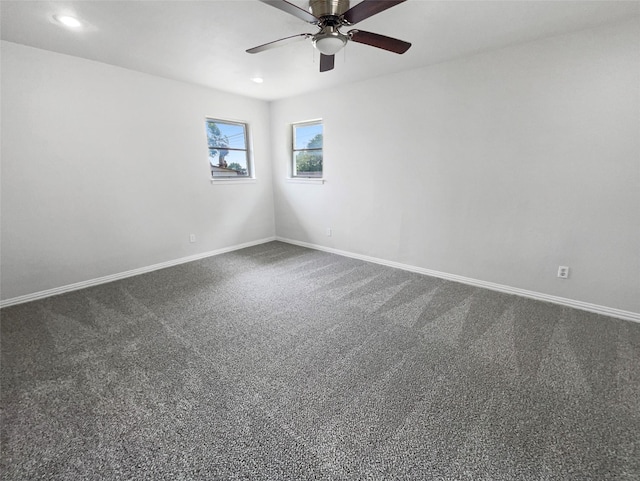 carpeted spare room with ceiling fan