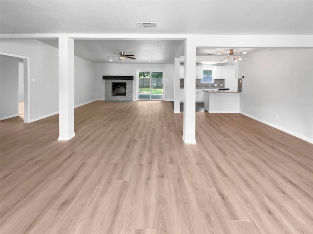 unfurnished living room featuring ceiling fan and light hardwood / wood-style flooring