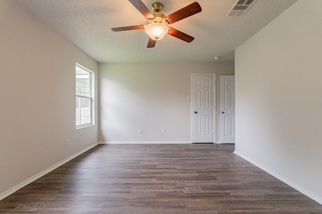 unfurnished room with ceiling fan, dark hardwood / wood-style floors, and a textured ceiling