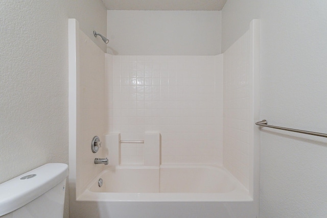 bathroom with shower / bath combination and toilet