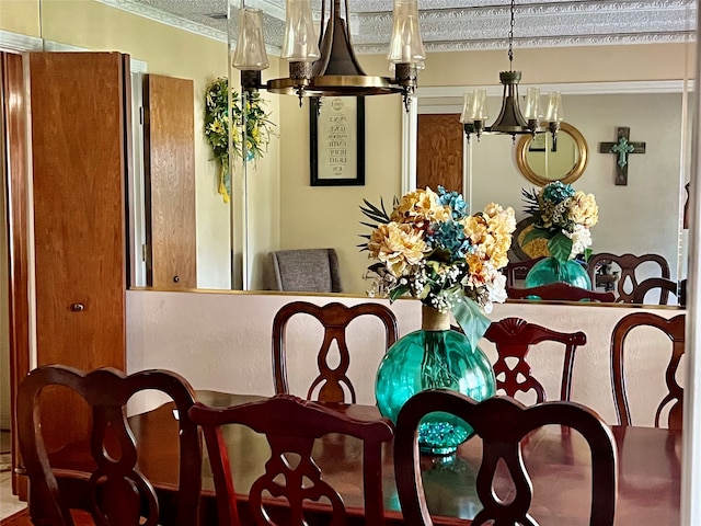 dining area featuring a notable chandelier and crown molding