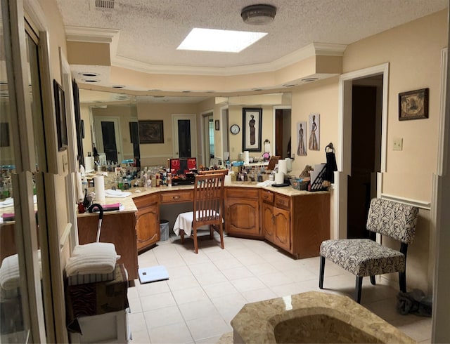 bathroom with tile flooring, a textured ceiling, and ornamental molding