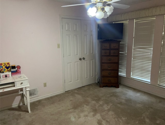 bedroom featuring carpet, ceiling fan, and a closet