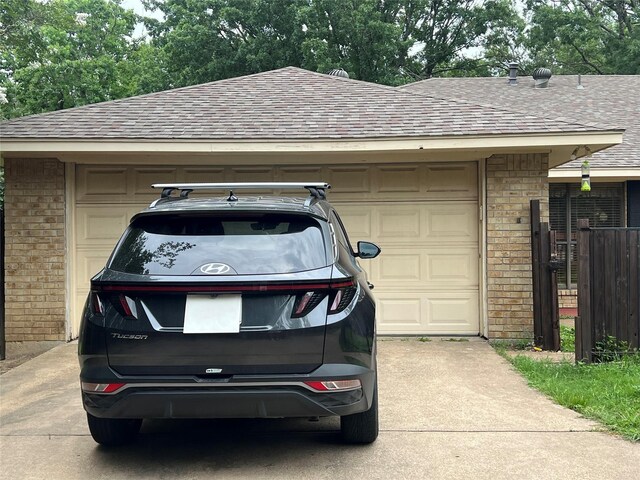 garage featuring concrete driveway