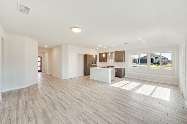 unfurnished living room featuring light wood-style flooring, recessed lighting, visible vents, and baseboards