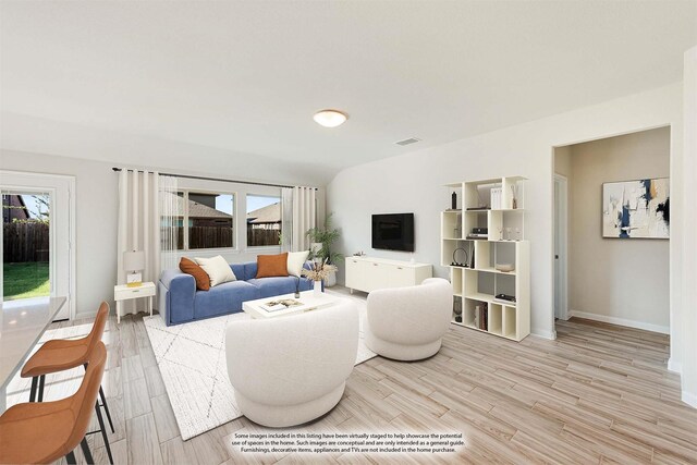 living room featuring plenty of natural light and light hardwood / wood-style floors