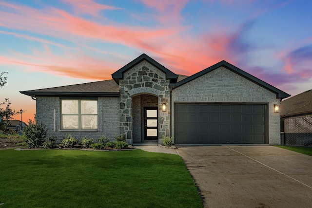 view of front facade featuring driveway, a garage, a lawn, and brick siding