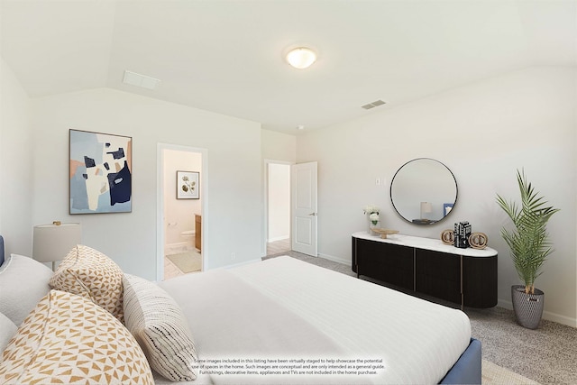 carpeted bedroom featuring connected bathroom and lofted ceiling