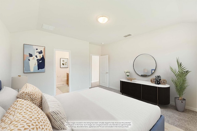 carpeted bedroom featuring lofted ceiling, ensuite bathroom, visible vents, and baseboards