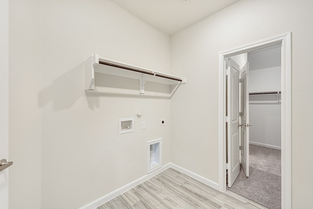 laundry area with hookup for an electric dryer, light carpet, gas dryer hookup, and washer hookup