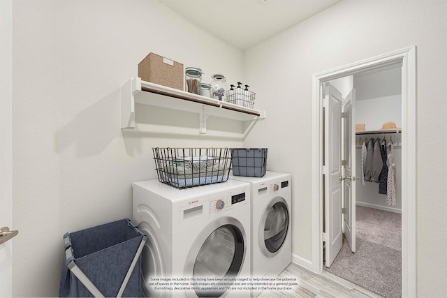 laundry room featuring laundry area, independent washer and dryer, and baseboards