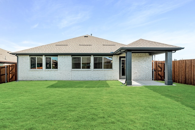 back of property with a patio and a yard