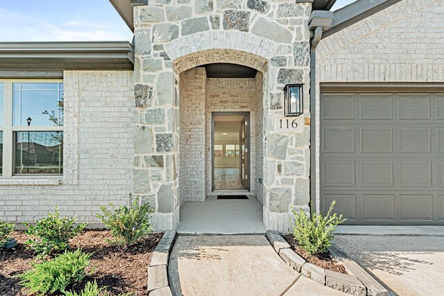 doorway to property featuring a garage