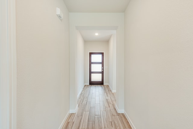 doorway to outside with light wood-type flooring