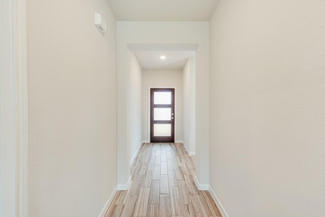 interior space featuring light wood-style flooring and baseboards