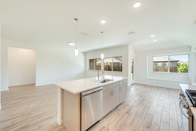 kitchen with plenty of natural light, a center island with sink, dishwasher, and stove