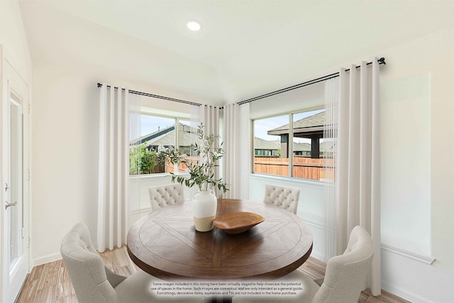 dining room featuring a wealth of natural light and light hardwood / wood-style flooring