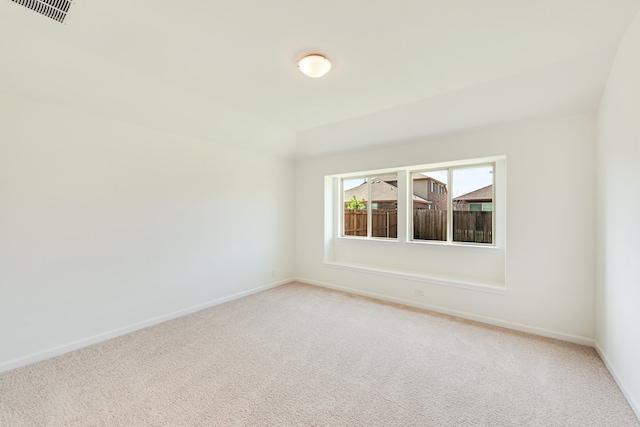 unfurnished room featuring light colored carpet