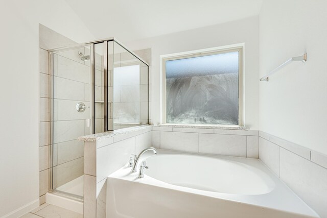 bathroom with tile patterned flooring and separate shower and tub