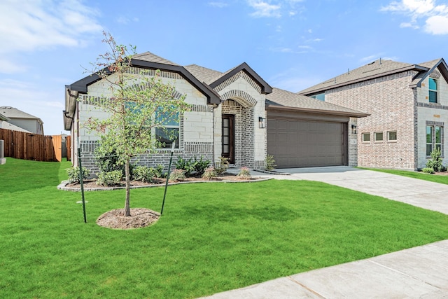 french provincial home featuring brick siding, concrete driveway, an attached garage, fence, and a front lawn