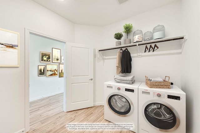 clothes washing area featuring laundry area, baseboards, light wood finished floors, and washer and dryer