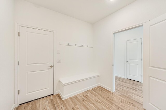 mudroom with light hardwood / wood-style flooring