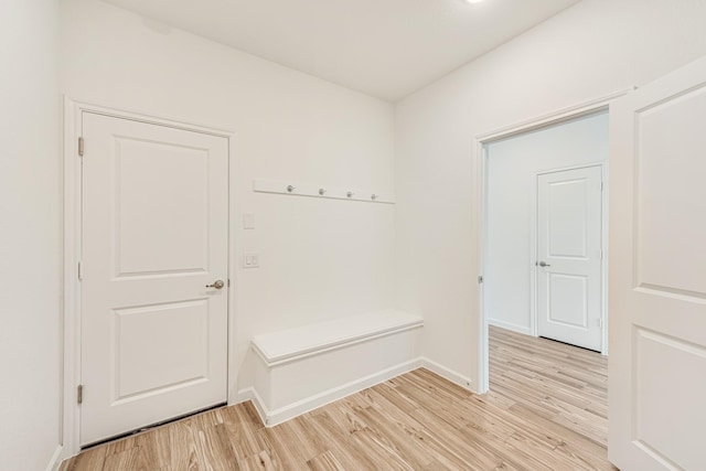 mudroom featuring light wood-style floors and baseboards