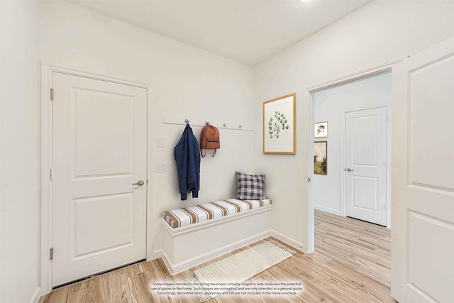 mudroom with light wood-style floors and baseboards