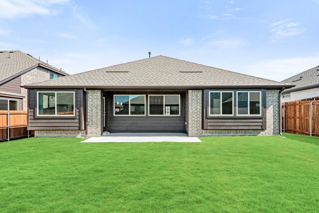 back of house featuring a patio area and a yard