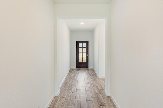 entryway featuring light wood-style flooring and baseboards