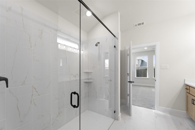 bathroom featuring vanity and a shower with shower door