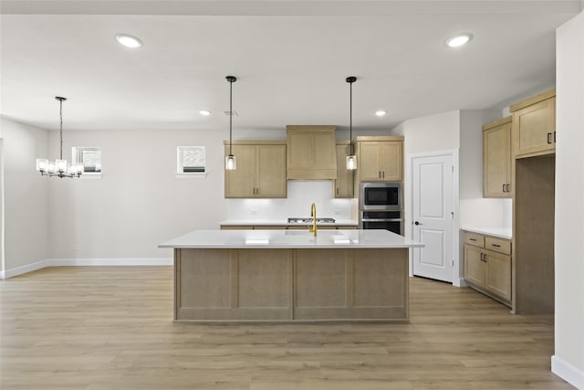 kitchen with premium range hood, a kitchen island with sink, light hardwood / wood-style floors, and stainless steel appliances