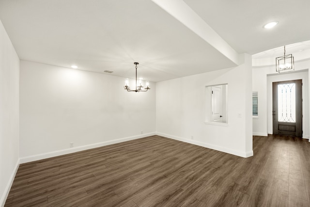 entrance foyer featuring a notable chandelier and dark wood-type flooring